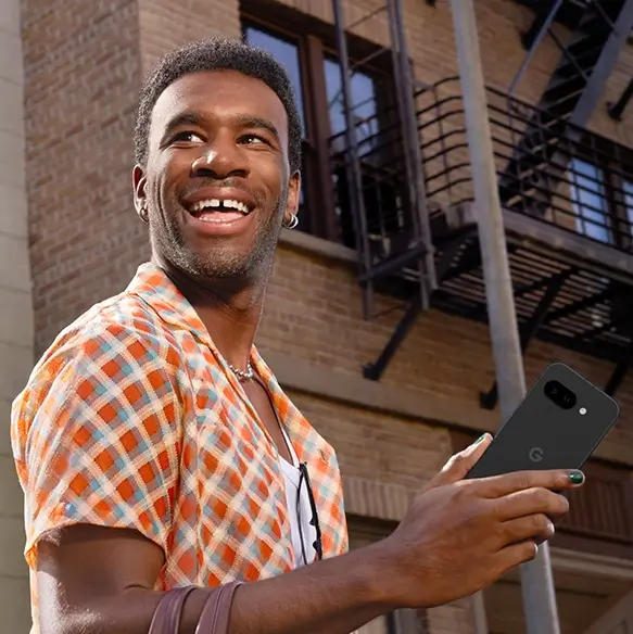 Happy guy holding Google Pixel 9a
